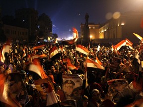 Egyptians wave the national flag and hold up pictures of Defence Minister army chief Abdel Fattah al-Sisi during a gathering in General Abdel Monim Riyad square at the edges of Cairo's Tahrir square on January 25, 2014. A spate of deadly bombings put Egyptian police on edge as supporters and opponents of the military-installed government take part in rival rallies for the anniversary of the 2011 Arab Spring uprising. (AHMED TARANH/AFP/Getty Images)