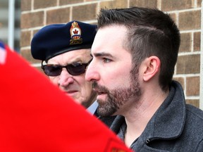 Canadian veterans Bruce Moncur, right, and Larry Costello attend a rally against the closure of the Veterans Affairs office in Windsor, Ont. on Jan. 31, 2014. (Nick Brancaccio / The Windsor Star)