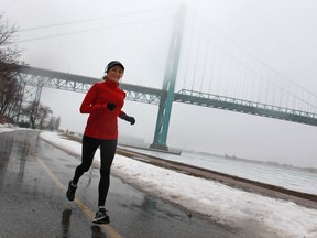Karen Reis takes advantage of the thaw in the weather to take a jog along Windsor's riverfront, Saturday, Jan. 12, 2014.  (DAX MELMER/The Windsor Star)
