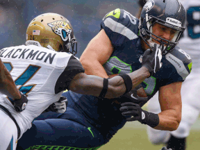 LaSalle's Luke Willson, right, is tackled by Jacksonville's Will Blackmon at CenturyLink Field in Seattle. (Photo by Otto Greule Jr/Getty Images)