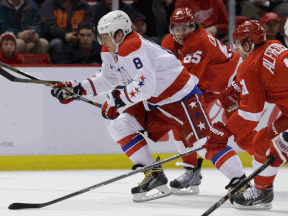 Washington's Alex Ovechkin, left, breaks away from Detroit's Danny DeKeyser, left, and Daniel Alfredsson Friday. (AP Photo/Carlos Osorio)