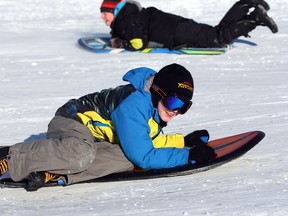 Evan Beadow, front, and his cousin, Max Beadow race down Malden Park toboggan hill Friday January 3, 2014. (NICK BRANCACCIO/The Windsor Star)