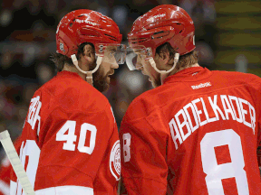 Detroit's Henrik Zetterberg, left, and Justin Abdelkader talk during the first period against Montreal at Joe Louis Arena. (Photo by Leon Halip/Getty Images)