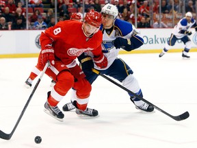 Detroit's Justin Abdelkader, left, is checked by Alexander Steen of the Blues. (AP Photo/Paul Sancya)