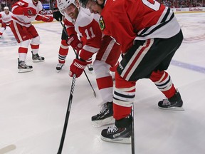 Chicago's Duncan Keith, right, battles with Detroit's Daniel Cleary at the United Center. (Photo by Jonathan Daniel/Getty Images)