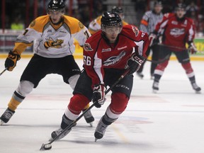 Windsor's Josh Ho-Sang, centre, carries the puck against the Sarnia Sting at the WFCU Centre. (DAX MELMER/The Windsor Star)