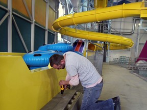 A carpenter works near the Master Blaster, one of two water rides which still requires certification at Adventure Bay.  Mayor Eddie Francis announced the opening for Adventure Bay at Windsor International Aquatic and Training Centre, presented by Windsor Family Credit Union,  will be delayed due to the lack of certification of two of the main aquatic rides, the Master Blaster and Whizzard, December 24, 2013.  (NICK BRANCACCIO/The Windsor Star)