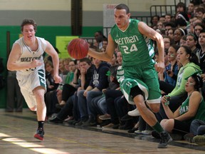 Herman's Tyler Storie, right, breaks out on the fast break ahead of Matthew Pendergast of Holy Cross. (DAX MELMER/The Windsor Star)