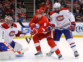 Detroit's Justin Abdelkader, centre, is checked by Montreal's P.K. Subban in front of goalie Carey Price Friday at Joe Louis Arena. (AP Photo/Paul Sancya)