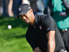 Tiger Woods hits a shot on the second hole on the South Course at Torrey Pines Saturday in San Diego. (AP Photo/Lenny Ignelzi)