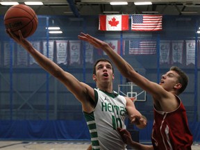 Herman's Marko Kovac, left, keeps the ball out of reach from Cardinal Newman's Marcus Zeba at the St. Denis Centre. (DAX MELMER/The Windsor Star)
