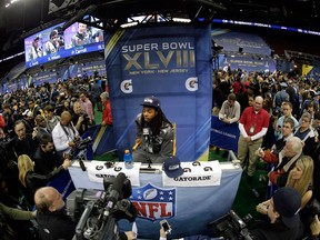 Seattle cornerback Richard Sherman, centre, speaks to the media during Super Bowl XLVIII Media Day at the Prudential Center in Newark, New Jersey. (Photo by Jeff Zelevansky/Getty Images)