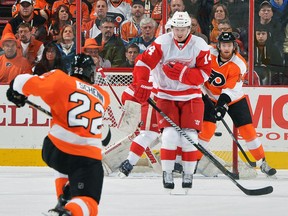 Detroit's Gustav Nyquist, centre, tries to block a shot by Luke Schenn of the Flyers at the Wells Fargo Center Tuesday. (Photo by Drew Hallowell/Getty Images)
