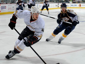 Ex-Spit Cam Fowler, left, is checked by Nashville's Matt Halischuk. (Photo by Frederick Breedon/Getty Images)