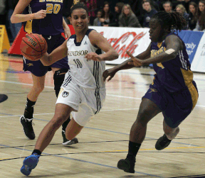 Windsor's Miah-Marie Langlois, left, drives by Laurier's Lee Anna Osei Wednesday at the St. Denis Centre. (DAN JANISSE/The Windsor Star)