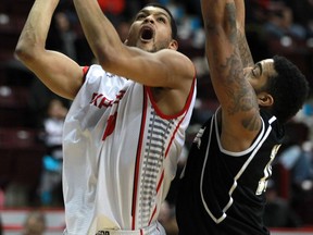 Windsor's Kevin Loiselle, left, takes a shot over Mississauga's Dwight McCombs at the WFCU Centre. (DAX MELMER/The Windsor Star)