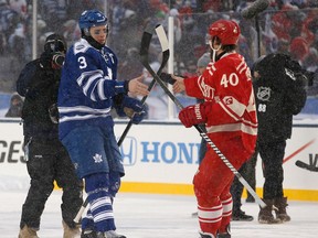 Toronto's Dion Phaneuf, left, shakes hands with Detroit's Henrik Zetterberg after the 2014 Bridgestone NHL Winter Classic at Michigan Stadium. (Photo by Gregory Shamus/Getty Images)