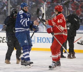 Toronto's Dion Phaneuf, left, shakes hands with Detroit's Henrik Zetterberg after the 2014 Bridgestone NHL Winter Classic at Michigan Stadium. (Photo by Gregory Shamus/Getty Images)