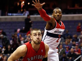 Toronto's Jonas Valanciunas, left, looks to dunk against Washington's John Wall Friday. (AP Photo/Alex Brandon)