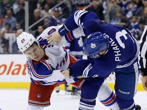 Toronto's Dion Phaneuf, right, fights New York's Chris Kreider Saturday. (THE CANADIAN PRESS/Mark Blinch)