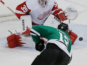 Dallas forward Alex Chiasson, left, takes a shot on Detroit goalie Jimmy Howard. (AP Photo/Brandon Wade)