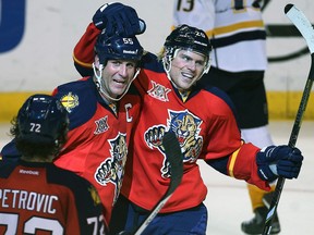 Windsor's Ed Jovanovski, centre, celebrates with Sean Bergenheim, right, after the Panthers scored a goal against Nashville Saturday. (AP Photo/J Pat Carter)