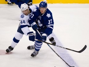 Toronto's Carter Ashton, right, is checked by Tampa Bay's Nate Thompson at the Air Canada Centre. (Aaron Lynett/National Post)