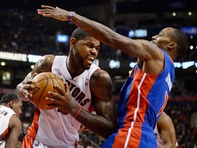 Toronto's Amir Johnson, left, drives to the net against Detroit's Brandon Jennings Wednesday. (THE CANADIAN PRESS/Frank Gunn)