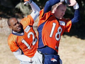 Broncos QB Peyton Manning, right, and wide receiver Andre Caldwell stretch during practice in Englewood, Colo., Friday, Jan. 17, 2014. The Broncos host the New England Patriots Sunday for the AFC championship. (AP Photo/Ed Andrieski)