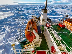 Russian ship MV Akademik Shokalskiy is trapped in thick Antarctic ice, 1,500 nautical miles south of Hobart, Australia on Friday, Dec. 27, 2013. The research ship was on a research expedition to Antarctica, when it got stuck after a blizzard's whipping winds pushed the sea ice around the ship, freezing it in place. (Australasian Antarctic Expedition/Footloose Fotography, Andrew Peacock/The Associated Press)