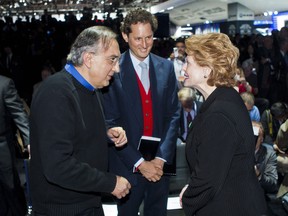 Chrysler Chairman Sergio Marchionne, left, greets Sen. Debbie Stabenow, right, with Fiat Chairman John Elkann, center, Monday, Jan. 13, 2014, at the North American International Auto Show in Detroit, Mich. (AP Photo/Tony Ding)