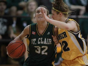 St. Clair's Tori Schutz, left, drives to the basket against Humber's Melissa Szilagyi in OCAA women's basketball at St. Clair College, Sunday, Jan. 12, 2013. (DAX MELMER/The Windsor Star)