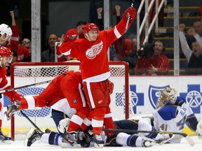 Detroit's Gustav Nyquist, centre, celebrates his goal against St. Louis goalie Jaroslav Halak Monday, Jan. 20, 2014, in Detroit.  Nyquist is on the short list to replace Johan Franzen on the Swedish roster for the Sochi Games. (AP Photo/Paul Sancya)