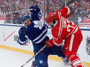 Detroit's Kyle Quincey, right, and Toronto's Phil Kessel battle for the puck during the Winter Classic at Michigan Stadium on January 1, 2014 in Ann Arbor. (Gregory Shamus/Getty Images)