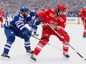 Toronto's Jerry D'Amigo, left, battles Detroit's Jakub Kindl during the NHL Winter Classic at Michigan Stadium on January 1, 2014 in Ann Arbor. (Gregory Shamus/Getty Images)
