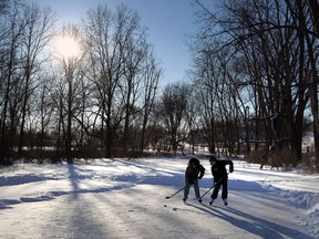 Brendan Semande and Ethan Shurgold (right) brave the cold as they play some outdoor hockey on the pond at Malden Park in Windsor on Tuesday, January 28, 2014.                        (TYLER BROWNBRIDGE/The Windsor Star)