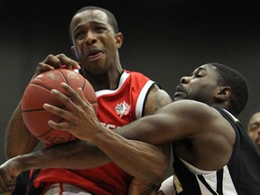 Windsor Express guard Stefan Bonneau, left, collides with London's Tony Bennett during the Clash at the Colosseum at Caesars Windsor on Wednesday, January 15, 2013. The Express won 86-78. (TYLER BROWNBRIDGE/The Windsor Star)