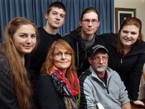 Mike and Patricia Schaafsma pose with their children, Hannah, 17, (L), Noah, 14, Zachary, 21, and Anita, 19, in Essex, Ont. on Mon. Jan. 13, 2014. The family's dream home in Kingsville burnt down earlier this month.   (DAN JANISSE/The Windsor Star)