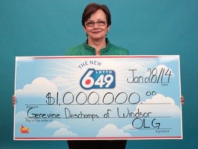 Genevieve Deschamps of Windsor holds her $1 million prize cheque from a Lotto 6/49 Guaranteed Millions draw. (Handout / The Windsor Star)