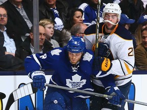 Leafs defenceman Tim Gleason, left, battles Buffalo's Drew Stafford during NHL action at the Air Canada Centre in Toronto, Ontario, Canada. (Graig Abel/NHLI via Getty Images)
