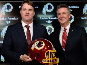 Jay Gruden, left, poses with Washington Redskins executive vice-president and GM Bruce Allen after he was introduced as the new head coach at Redskins Park on January 9, 2014 in Ashburn, Va. (Patrick McDermott/Getty Images)