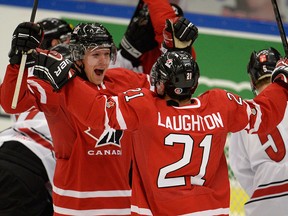 Canada's Griffin Reinhart (left) and Scott Laughton (21) celebrate Canada's first goal during first period, quarter-final IIHF World Junior Hockey Championship action in Malmo, Sweden on Thursday, January 2, 2014. THE CANADIAN PRESS/Frank Gunn