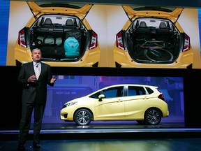 John Mendel, executive vice-president of auto sales for American Honda Motor Co., introduces the new 2015 Honda Fit at the press preview of the North American International Auto Show in Detroit. ( Bill Pugliano/Getty Images)