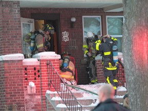 Windsor Firefighters prepare to enter an apartment building in the 600 block of Janette Avenue in Windsor, Ontario.  Careless cooking was blamed for the blaze which caused $80,000 in damages. Five people were displaced by the fire and one was treated for minor smoke inhalation.   (JASON KRYK/The Windsor Star)