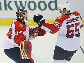 Florida goalie Tim Thomas, left, celebrates a shootout win over the Detroit Red Wings with Windsor's Ed Jovanovski at Joe Louis Arena on January 26, 2014 in Detroit, . The Panthers defeated the Wings 5-4 in a shootout (Leon Halip/Getty Images)