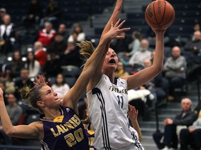 Laurier's Whitney Ellenor (L) and Windsor's Jessica Clemencon battle for the ball during their game Wed. Jan. 29, 2014, at the St. Denis Centre in Windsor, Ont.   (DAN JANISSE/The Windsor Star