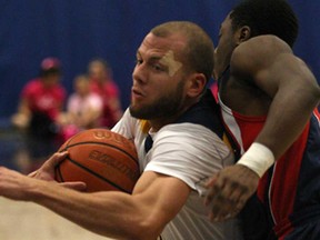 Windsor's Enrico Diloreto, left, drives to the basket against Brock in OUA men's basketball action at the St. Denis Centre, Saturday, Jan. 18, 2014. (DAX MELMER/The Windsor Star)