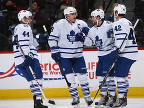 Toronto's Phil Kessel, second from right, celebrates his goal against Colorado with teammates Morgan Rielly, left, Dion Phaneuf and Tyler Bozak January 21, 2014 in Denver. (Doug Pensinger/Getty Images)