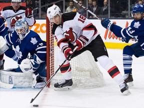 New Jersey's Steve Bernier, front, tries to wrap the puck around against Maple Leafs goalie Jonathan Bernier, left,  in Toronto on Sunday, January 12, 2014. (THE CANADIAN PRESS/Nathan Denette)