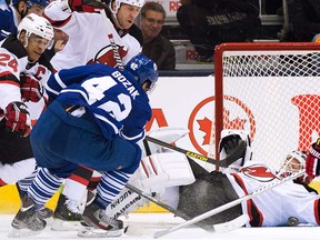 Maple Leafs forward Tyler Bozak, left, scores a goal against New Jersey's Corey Schneider, right, in Toronto on Sunday, January 12, 2014. (THE CANADIAN PRESS/Nathan Denette)